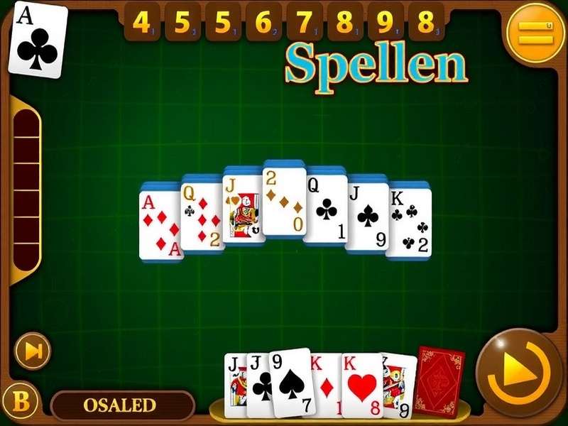 A hand placing the final King card in a game of Solitaire on a wooden table